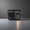 The black portable radio features an ultra-thin design, FM frequency modulation, digital display and is battery-powered Specification image